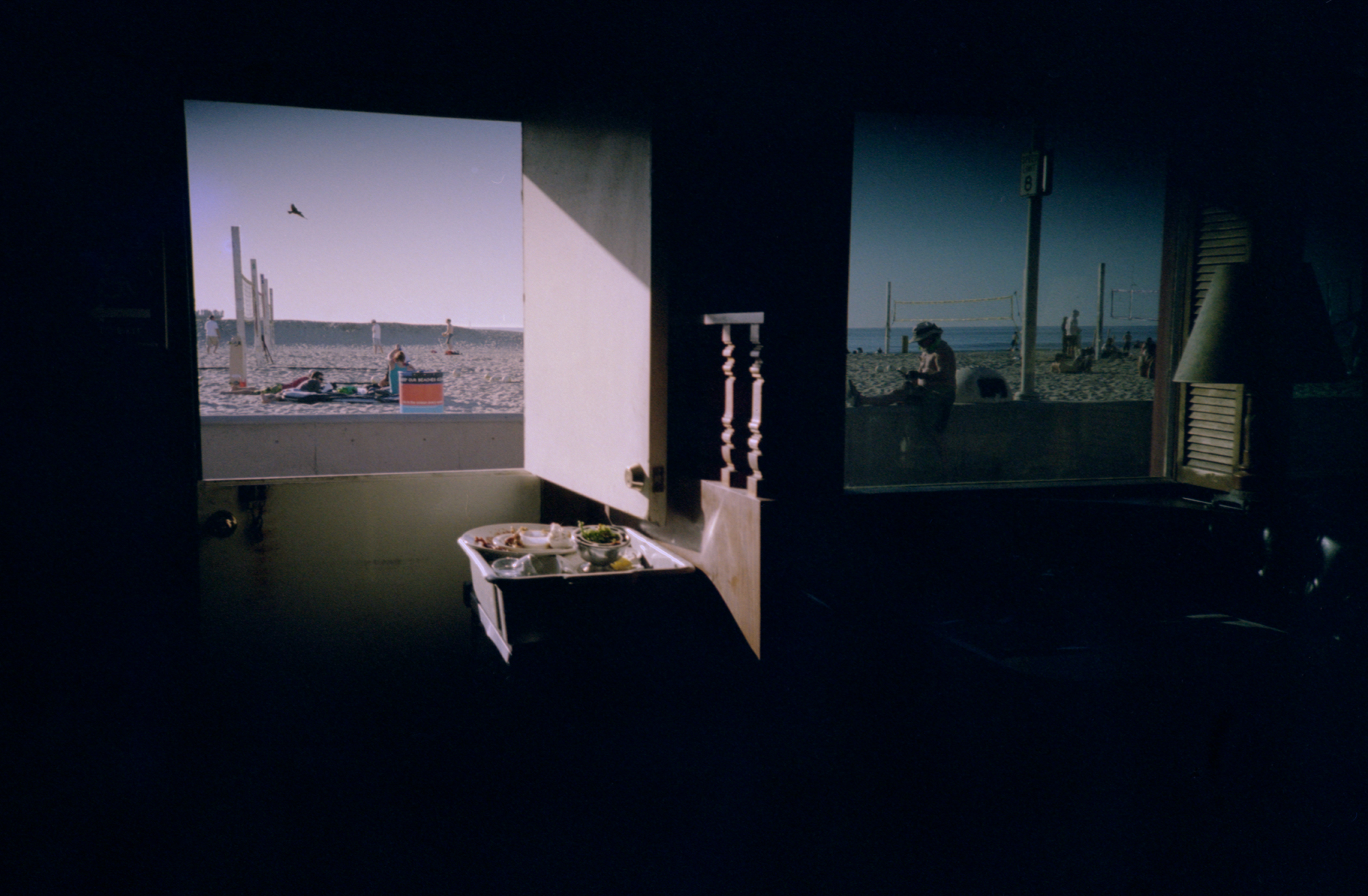 Y2K Dayshifting — a dark dive bar looking out onto a sunny Hermosa Beach, California in spring 2000.